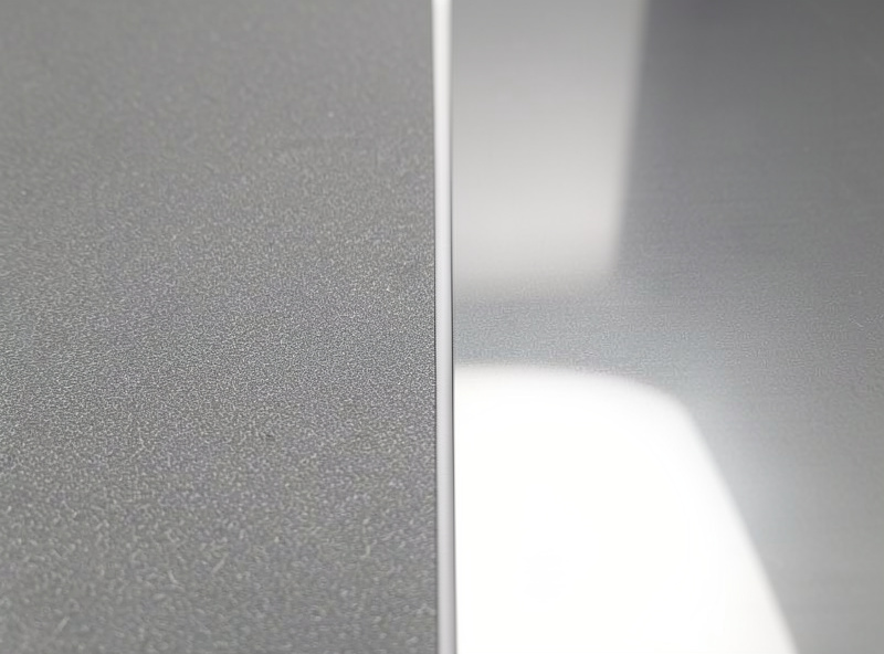 Textured and smooth PEI spring steel build plate sheets fanned out on a workshop bench