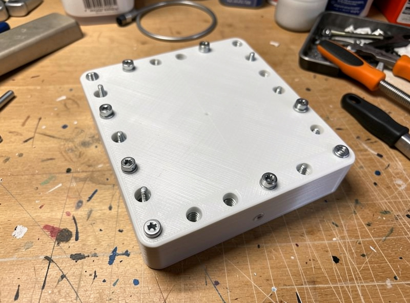A finished 3D printed enclosure assembled with screws threaded into heat-set inserts