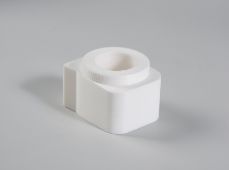 A 3D-printed part lit by soft window light with a white card bouncing fill onto the shadow side