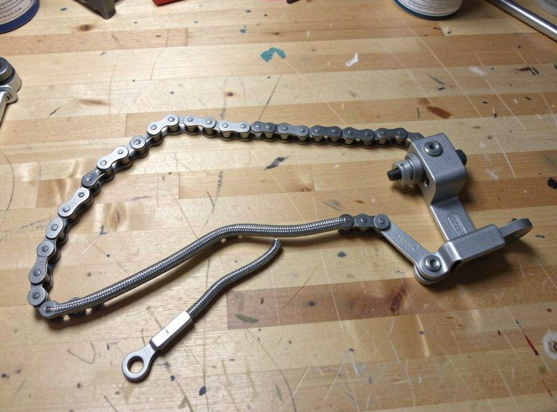 A collection of print-in-place mechanisms including a chain and a hinge on a workbench