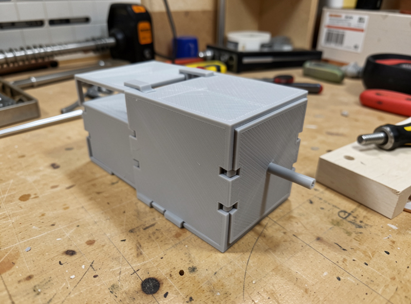 A 3D printed enclosure assembled with snap-fit clips and a press-fit peg