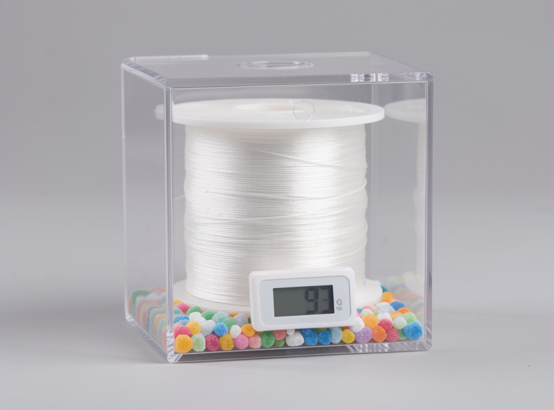 Nylon filament spool in a sealed dry box with indicating desiccant and a digital hygrometer